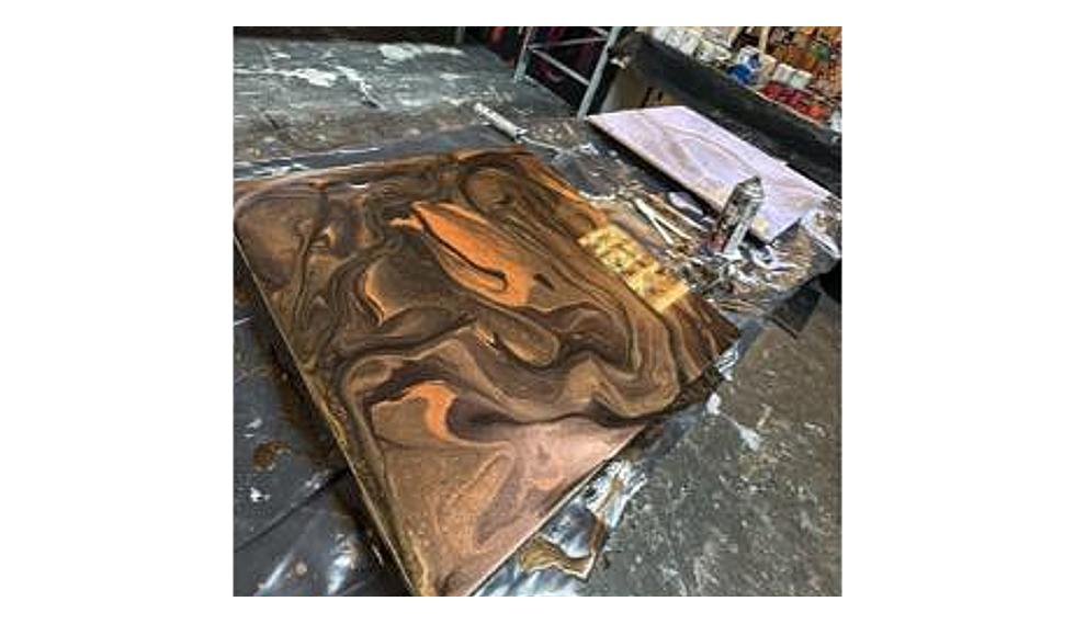 Bronze and black swirled resin pour